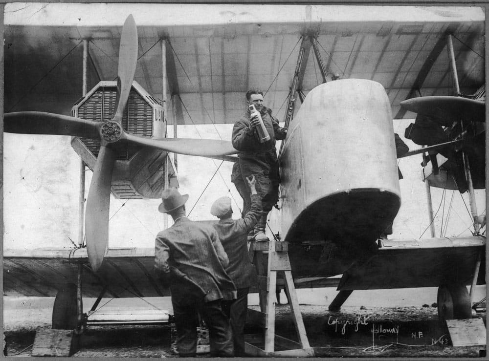 Captain John Alcock stowing provisions aboard Vickers Vimy aircraft before flight 