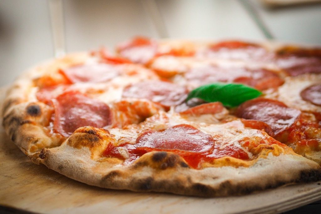 Enjoy a slice of pizza at Pizzeria Novecento for a true Italian experience.