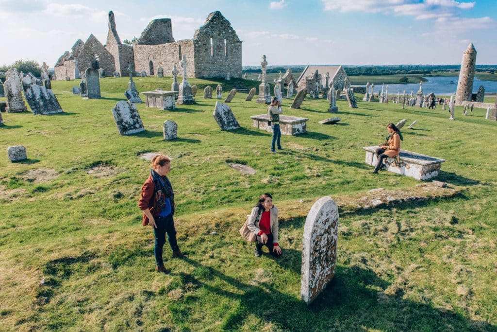 People in a graveyard on a nice day.