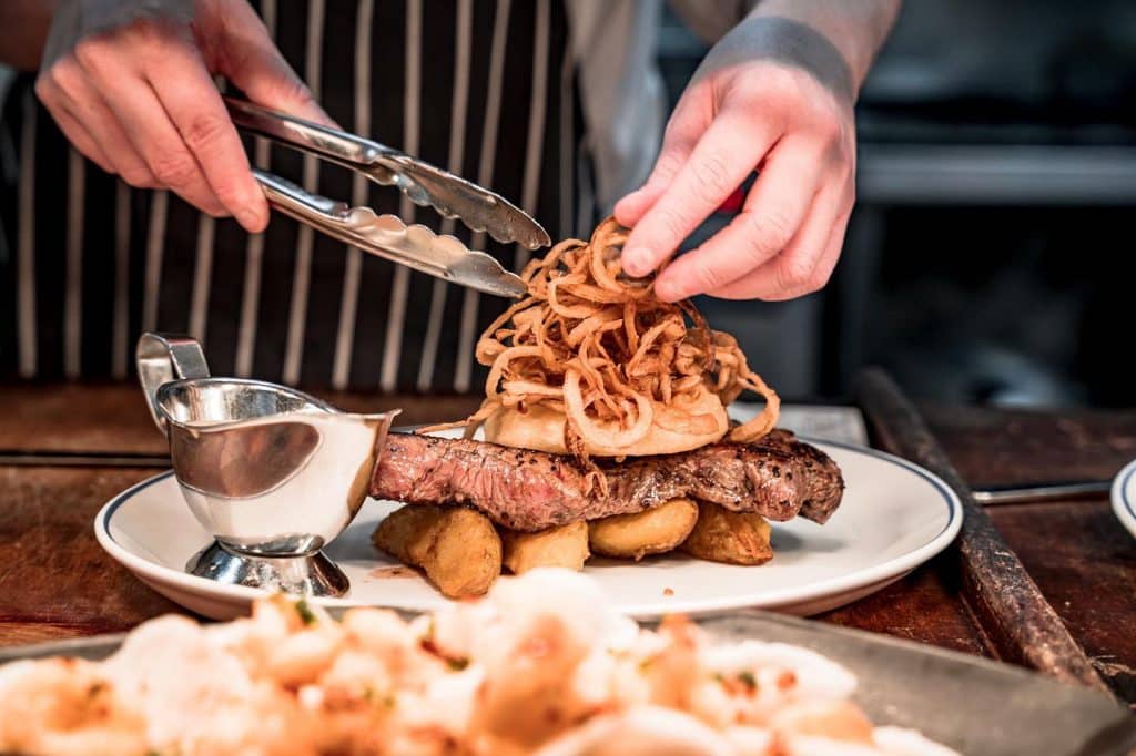 Stop for some dinner at the Ramore on one of the top day trips from Belfast.