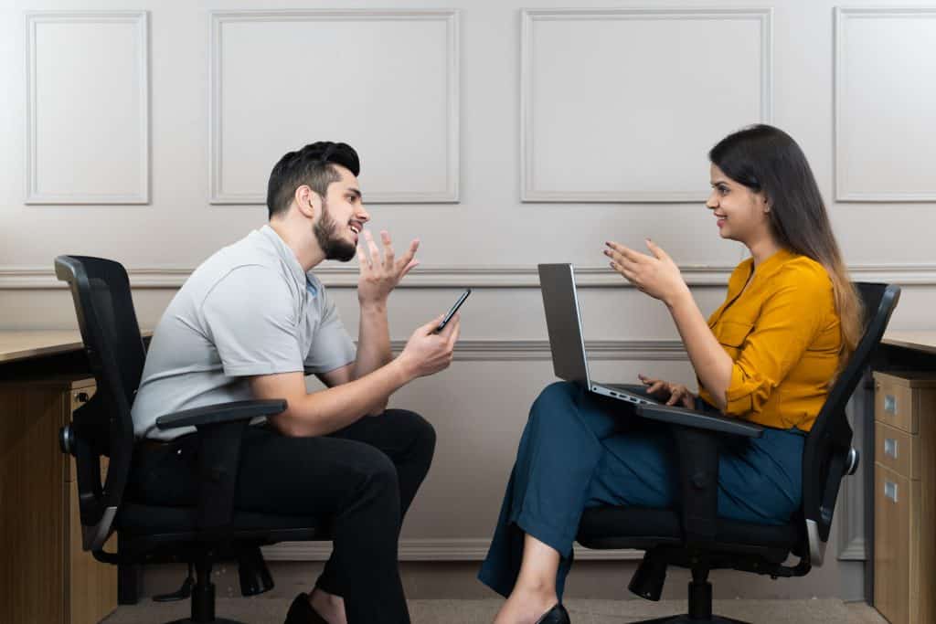 Two people at a table chatting.