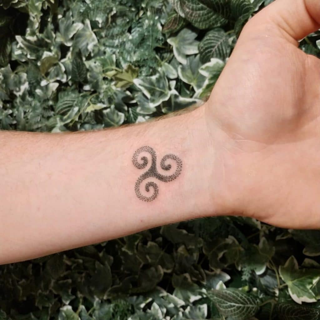 A Triskelion or Triskele tattoo.