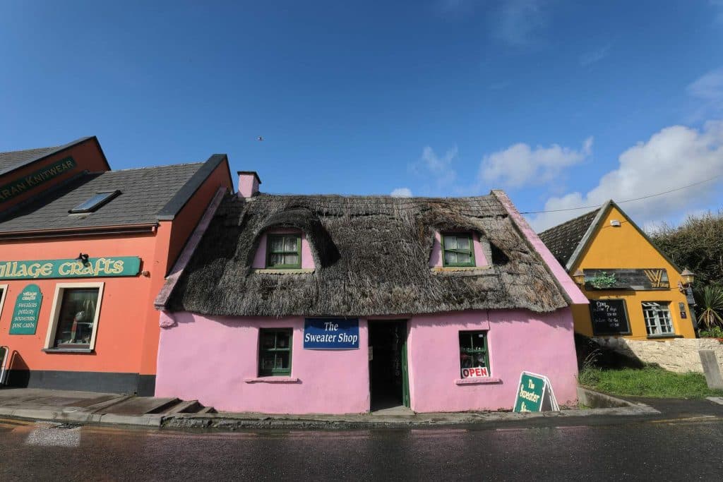 Lovely row of colourful thatched houses. This includes the pink Sweater Shop.