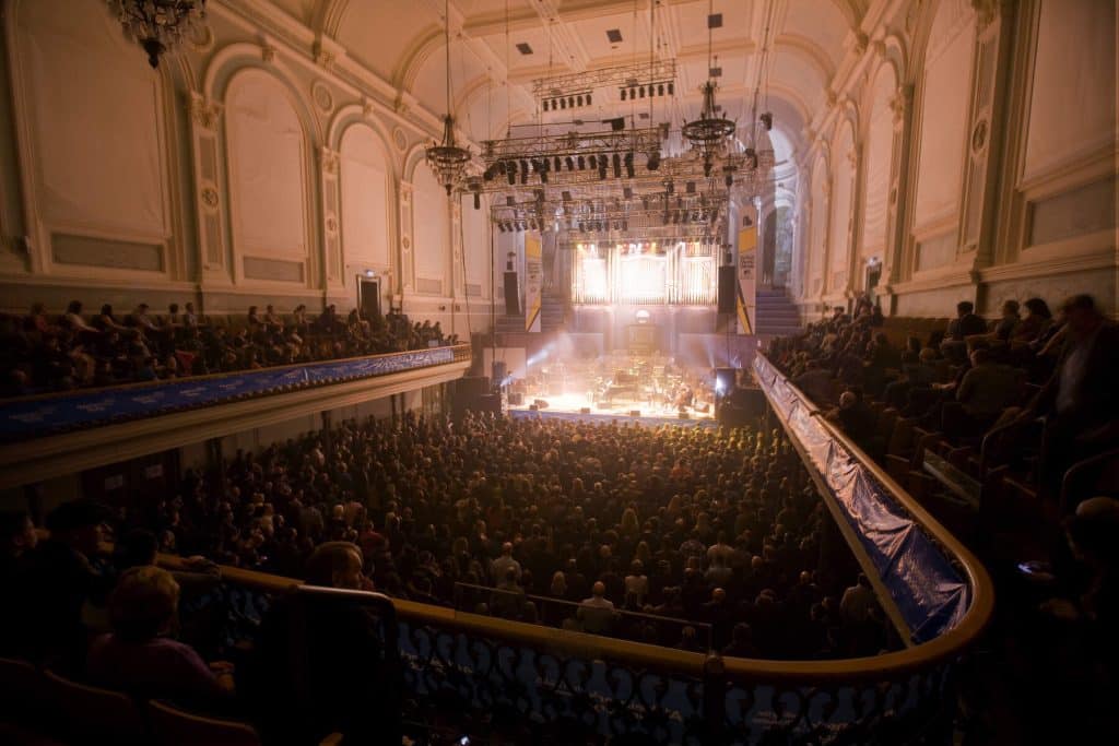 A packed Ulster Hall watch musicians performing on stage. The gigs are one of the arguments for picking Belfast over Dublin.
