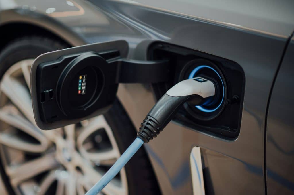 An electric car charging at an EV charging station.