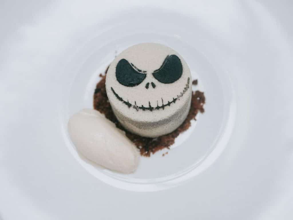 A whimsical skeleton-themed cake from A Peculiar Tea restaurant, one of Belfast's must-visit foodie destinations, showcasing intricate details and creative design, perfect for adding a touch of spookiness to any occasion.