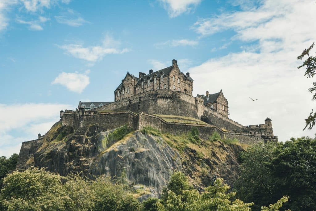 A shot of Edinburgh Castle and its surrounding nature on a bright day.