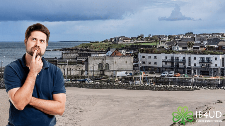 A promotional graphic for "Ireland Before You Die" (IB4UD) featuring a thoughtful man in a navy polo shirt looking upward with his hand on his chin. He is superimposed over a wide-angle coastal view of Balbriggan Beach and Harbour under a dramatic, cloudy sky.