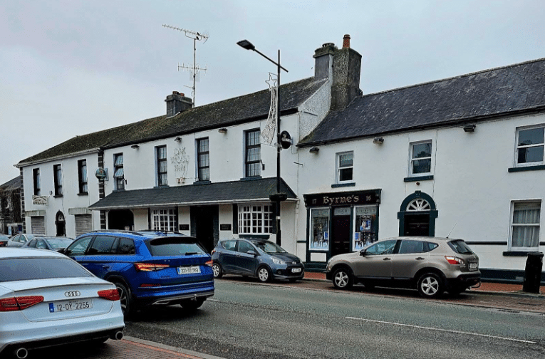 A street-view image of Byrne's Bar, a traditional white-fronted Irish pub with dark green trim, located on a main road in Edenderry, County Offaly.