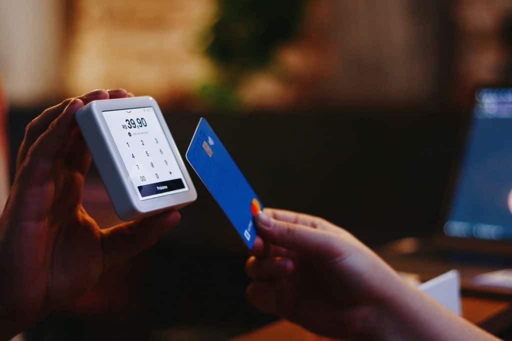 Picture of someone paying with a bank card.