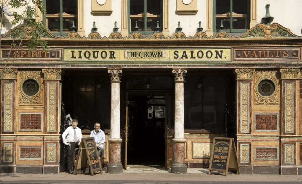 Two men in front of the Crown Bar in Belfast.
