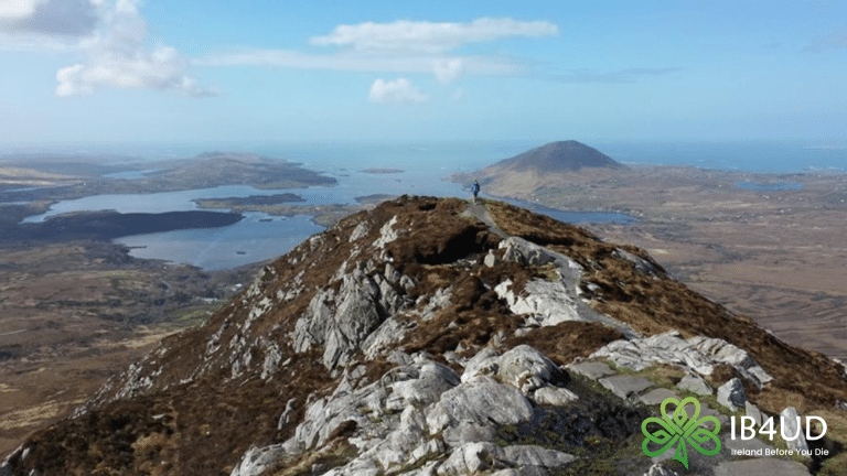 Hiker standing on top of Diamond Hill with views to the sea