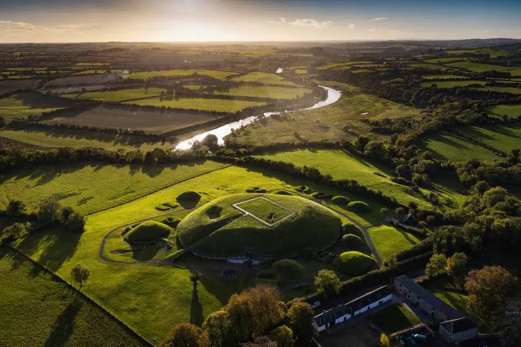 Aerial view of Newgrange and river in Boyne valley.