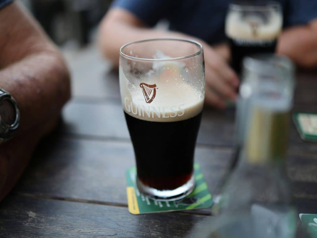 A half full glass of guinness.
