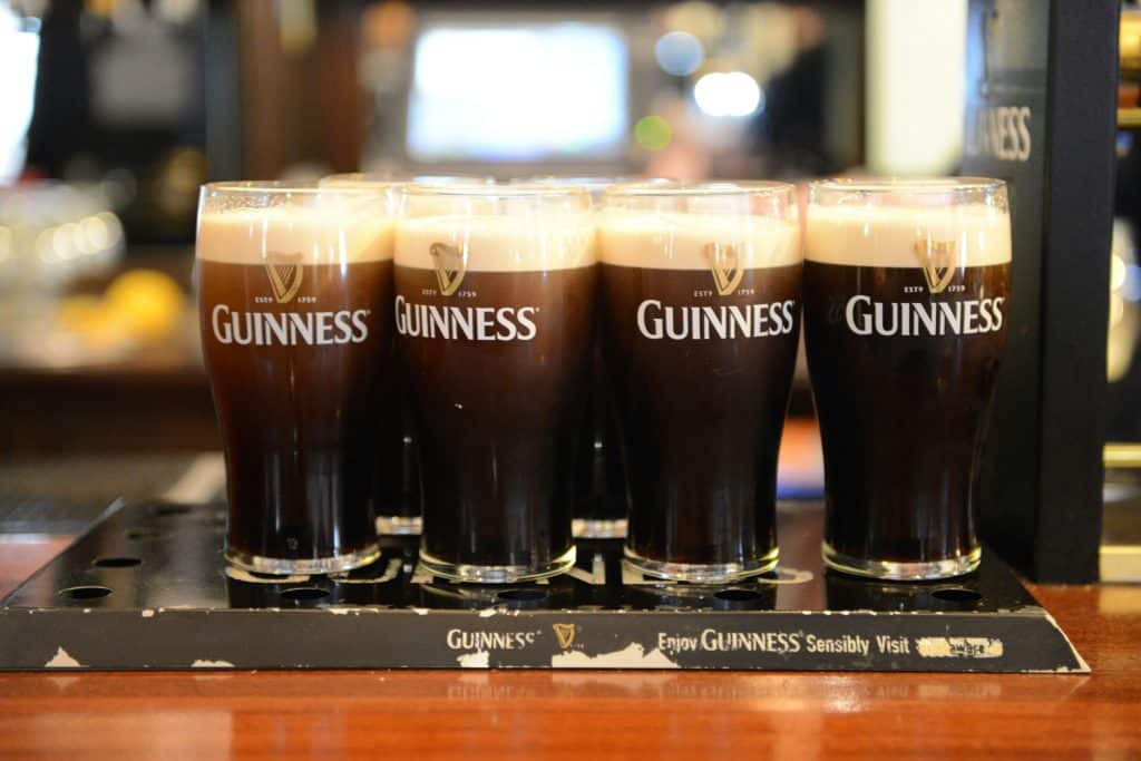 A few pints of Guinness lined up on the bar, settling.